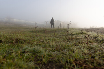 Wall Mural - Man in the foggy morning in the countryside landscape with mist