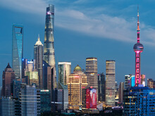 Modern Skyscrapers, Shanghai Tower, Jin Mao Tower, Oriental Pearl TV Tower And Shanghai World Financial Center, Landmarks In Lujiazui With Blue Sky Background In Dusk