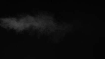 Wall Mural - Real jet steam looking like smoke isolated on black background. Clouds of white fantasy smoky abstract magic mystic fog toxic gas fumes pollution. Real speed motion. Camera locked down. Rec. in 60fps.