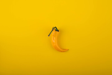 Wall Mural - Hot chilli pepeper on yellow background.