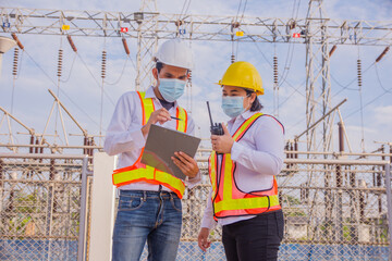 Wall Mural - Teamwork Electrician Engineer standing on factory power plant, Teamwork  Electrician Engineer concept