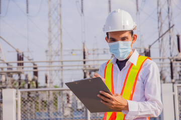 Wall Mural - Asian Electrician Engineer standing on factory power plant, Portrait Electrician Engineer concept