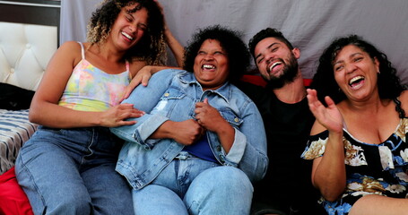 Happy Brazilian family laughing together. Casual hispanic latin people laugh, real life