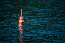 A Lobsterman's Buoy Floats In The Water Off The Coast Of Maine.