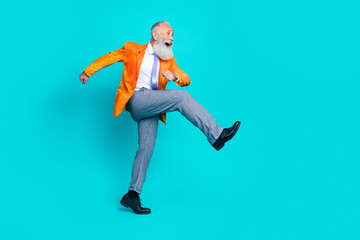 Full body profile portrait of crazy funky person walk look empty space isolated on aquamarine color background