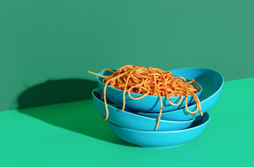 Wall Mural - Spaghetti with tomato sauce minimalist on a green background