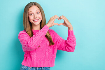 Sticker - Photo of optimistic good mood girl with straight hairstyle wear pink knit sweater showing heart symbol isolated on blue color background