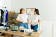 © AntonioDiaz - Smiling friends showing their t-shirts of their online print on demand business