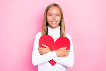 Sticker - Photo of adorable cheerful girl hands hold embrace red paper heart card isolated on pink color background