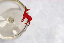 Overhead View Of A Reindeer Ornament On The Rim Of A Champagne Glass