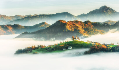 Wall Mural - Tomaz, Slovenia: St Thomaz church among white fog