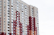 Multi-storey modern new red residential building against the sky