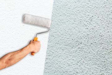 Wall Mural - painting hand with roller and wall background