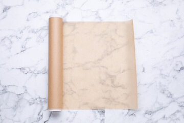 Canvas Print - Roll of baking paper on white marble table, top view