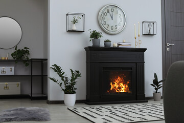 Canvas Print - Stylish living room interior with fireplace and green plants