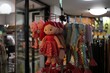 Closeup shot of cute cloth dolls hanging on a rack at a store