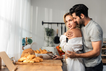 Wall Mural - Caucasian young hot sexy couple baking bakery foods in kitchen at home.