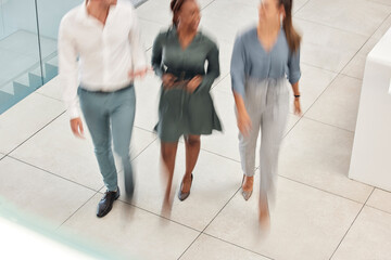 Wall Mural - Walking, blurred motion and office with a business man and woman team at work together from above. Working, collaboration and moving with a male and female employee group taking a walk at speed