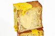 Closeup of sliced puff pastry cube shaped croissant with vanilla custard, yellow glaze and chocolate chips
