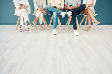 Poster - Feet, team and business people sitting in the office waiting for job interview, presentation and meeting to start. Technology, diversity and group of workers on row of chairs with smartphone in hands