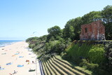 Fototapeta Pomosty - Castle ruins by the sea. Beach in summer.