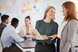 © C Daniels/peopleimages.com - Female colleagues tablet, planning meeting with smile and talking discussion at finance business. Women conversation together, happy with mobile technology at business meeting or social communication
