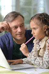 Poster - Portrait of father with daughter use laptop