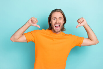 Sticker - Photo of young funny handsome attractive student guy wear orange t-shirt positive fingers directing himself egocentric isolated on blue color background