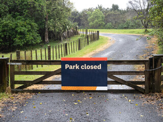 Wall Mural - Park closed sign. Wooden park gate. Copy space stock photo.