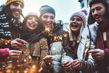 Fototapeta Londyn - Close up image of happy friends enjoying out with sparklers - Group of young people celebrating new year eve with fireworks - Holidays and friendship concept
