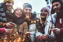 Close Up Image Of Happy Friends Enjoying Out With Sparklers - Group Of Young People Celebrating New Year Eve With Fireworks - Holidays And Friendship Concept