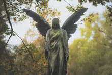 Angel Statue At The Cemetery In Fall