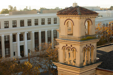 Wall Mural - Late afternoon sun shines on the historic church and downtown of the bay area city of Alameda, California, USA.