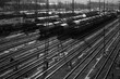 Railway Freight Station panorama in Hagen Vorhalle Westphalia Germany with many different mixed cargo trains on parallel curved rails waiting for shunting. Black and white greyscale with sunlight.