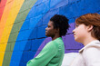 © VISTA by Westend61 - Thoughtful woman with friend by rainbow colored wall