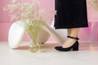 Women legs and feet in black high heels shoes in pink room