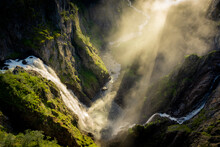 Amazing Sunbeams Passing Through The Mist Created By The Voringfossen  Waterfalls, Norway
