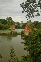 Poster - Vertical shot of lake with stacks covered in trees, Buu Long, Ho Chi Minh City, Vietnam