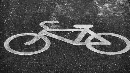 Poster - white drawing of a bicycle on the pavement with flashing white scratches