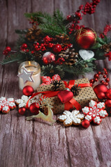 Wall Mural - Christmas background. Decorations, Gingerbread cookies, cones, cones and fir tree branches on old wooden rustic  table. symbol of festive winter season.