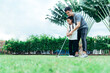 Happy asian family in the garden, Father and doughter. They are having fun playing golf in home garden together