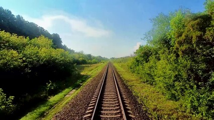 Wall Mural - View from the train window on the rails going into the distance