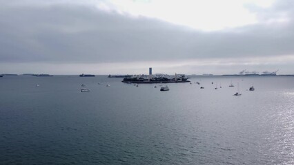 Sticker - Aerial footage of a big factory surrounded by small ships and boats sailing in the vast ocean