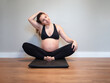 Pregnant woman stretching her trapezius muscles