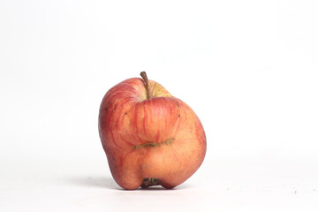 Concept of ugly food - red apple on white background