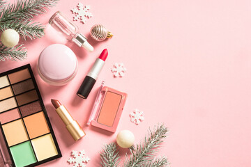 Fototapete - Make up cosmetic products and christmas decorations at pink. Flat lay image with copy space.