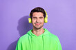 Portrait of relaxed glad pleasant guy brunet hairdo wear green hoodie headphones enjoying playlist isolated on violet color background