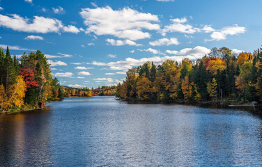 Autumn leaves and trees surround Chateaugay Lake in Ellenburg in New York State