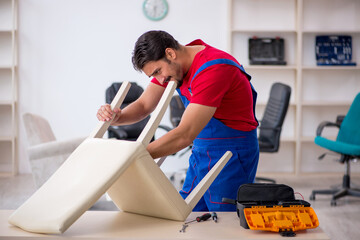 Young male carpenter working at workshop