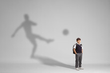 Schoolboy In A Uniform Posing With A Football Player Shadow